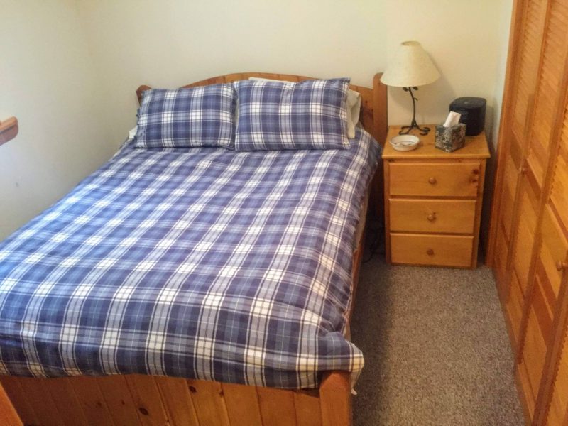 Main-floor queen bedroom with plaid bedding