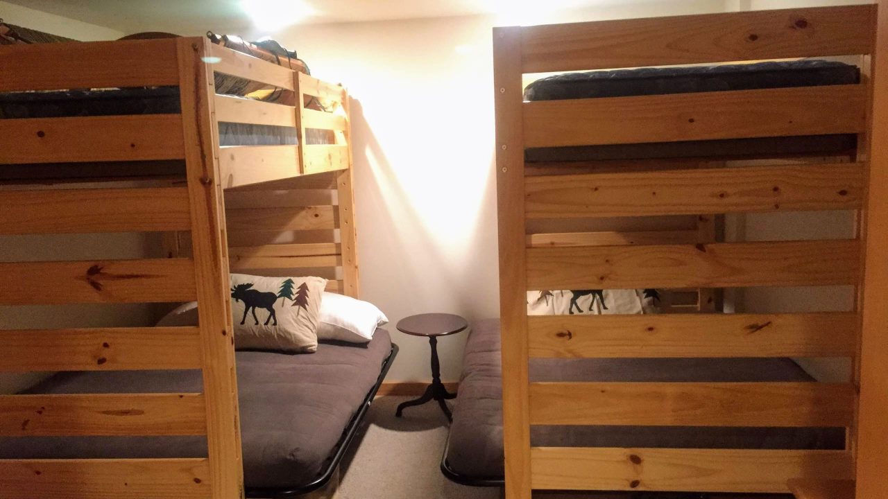 Ground-floor bunk room: two bunk units, a full bed below and a single above