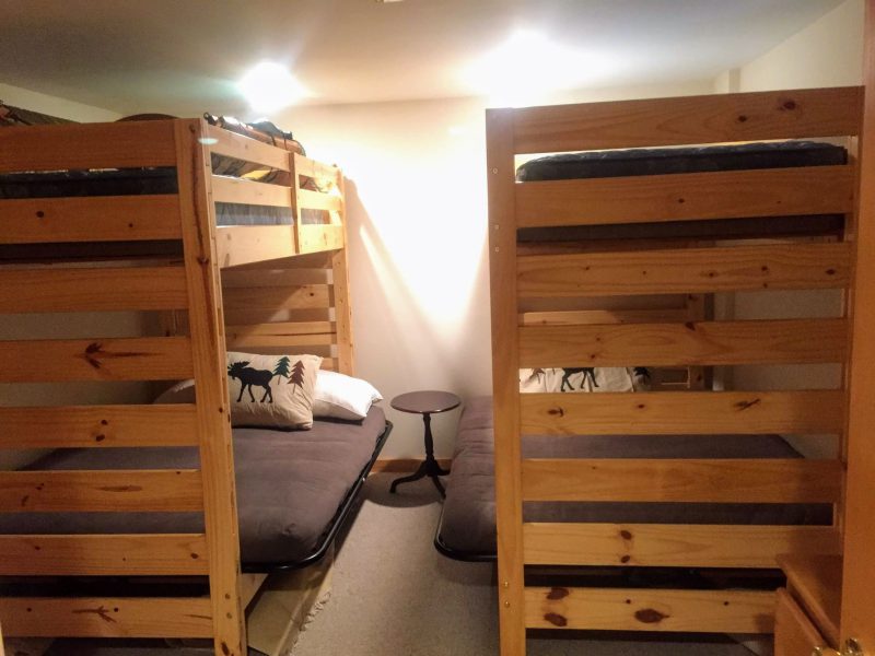 Ground-floor bunk room: two bunk units, a full bed below and a single above