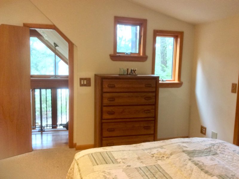 Bedroom with a dresser and an A-frame window